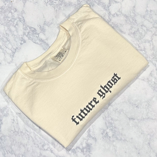 A cream Comfort Colors t-shirt with the text 'future ghost' embroidered in black thread on the front.