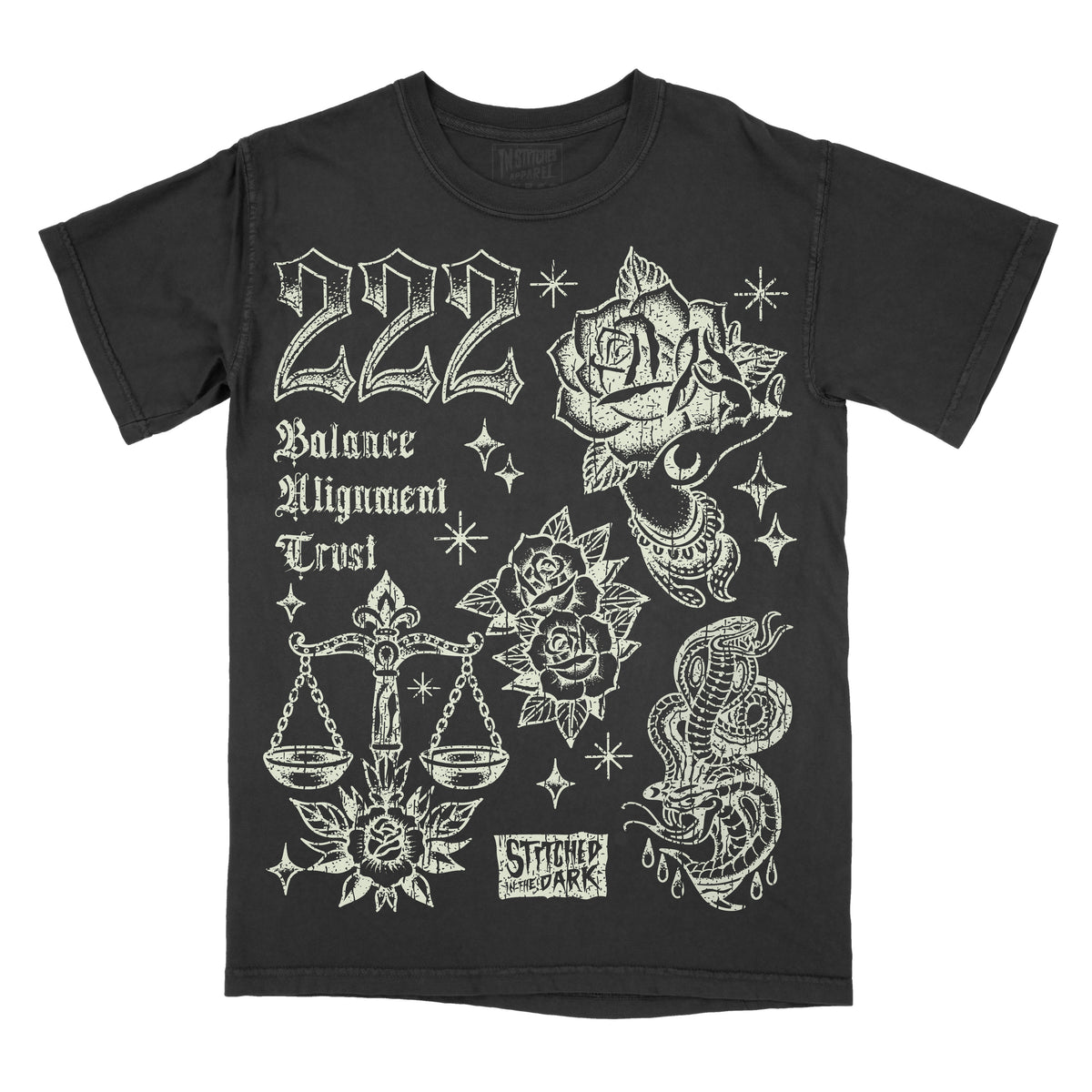 black T-shirt featuring a distressed 222 angel number design with roses, a mystical hand, balance scales, snakes, and stars, with text reading “Balance,” “Alignment,” and “Trust,” plus Stitched in the Dark branding.