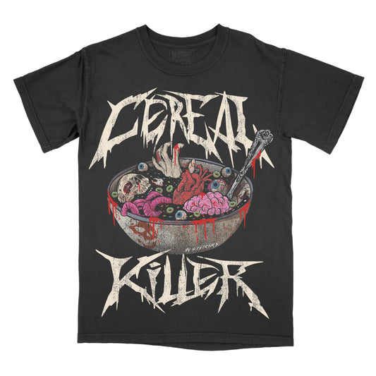 Black graphic t-shirt featuring the phrase “Cereal Killer” in jagged, horror-style lettering above and below an illustration of a cereal bowl filled with eyeballs, brains, and bloody details, with a spoon dripping red liquid.