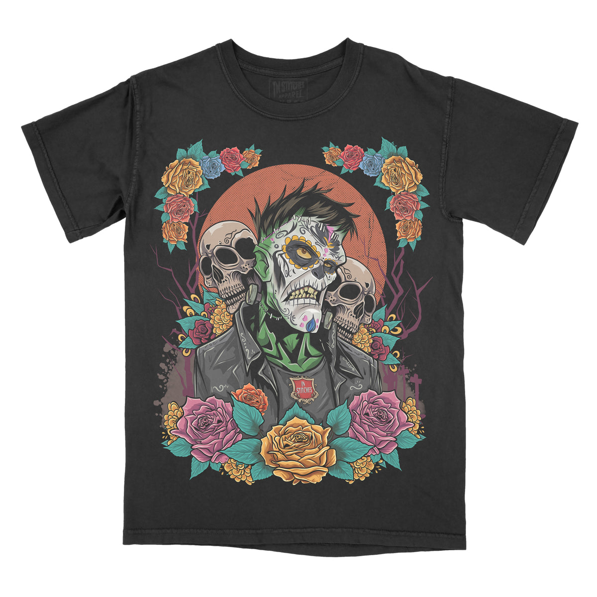 Black garment-dyed graphic t-shirt featuring an original Frankenstein-inspired Day of the Dead design with sugar skull details, colorful floral artwork, and gothic horror aesthetics.