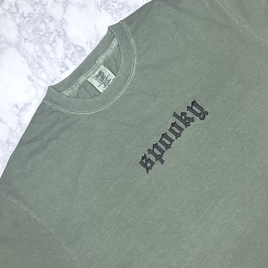 Green embroidered t-shirt with the word 'SPOOKY' in black thread on the front.