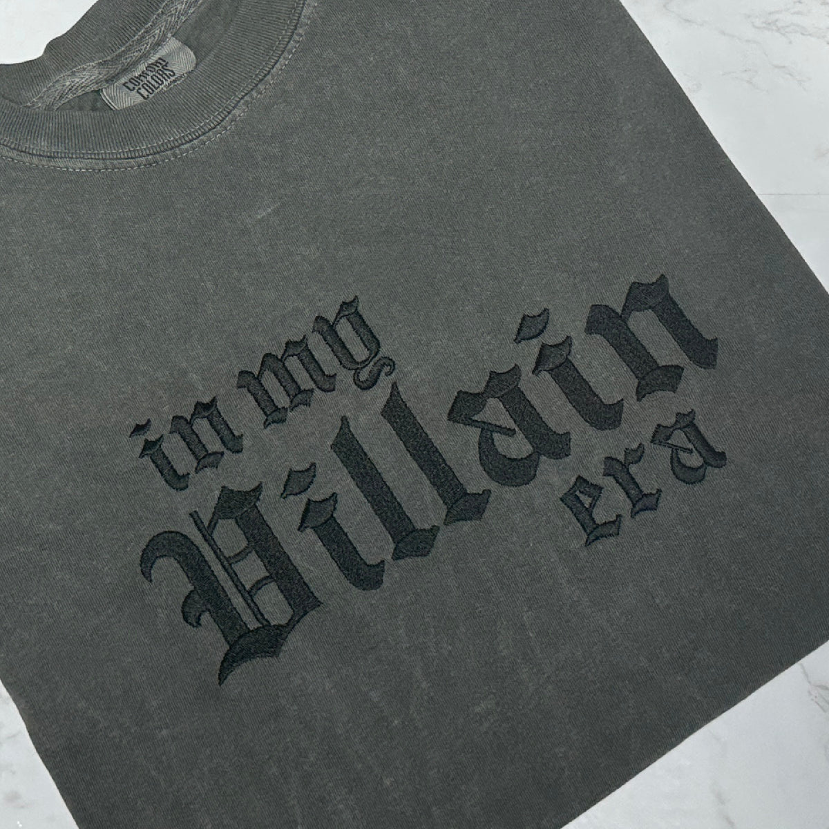 Pepper t-shirt with black gothic text reading “in my villain era” across the front.