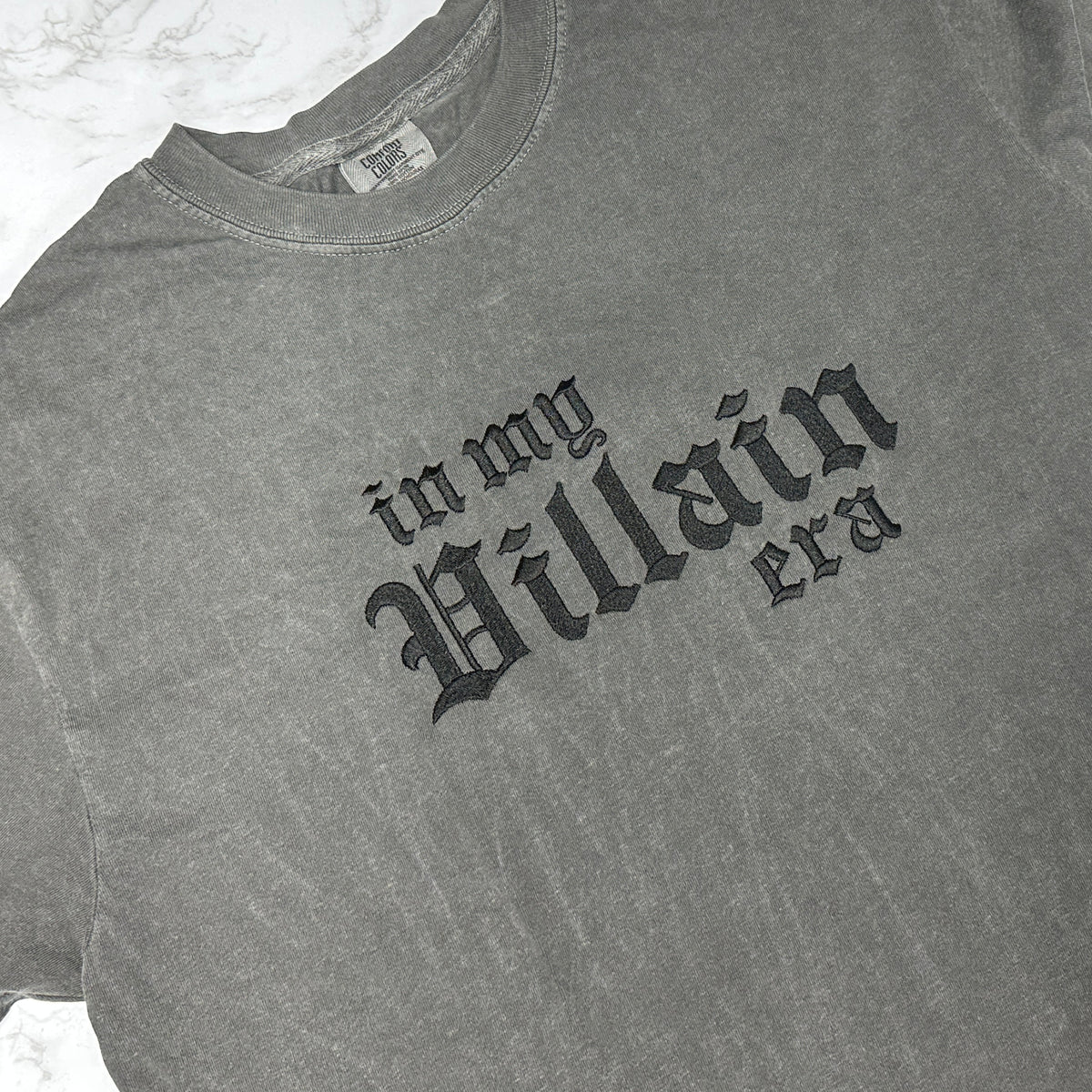 Pepper t-shirt with black gothic text reading “in my villain era” across the front.