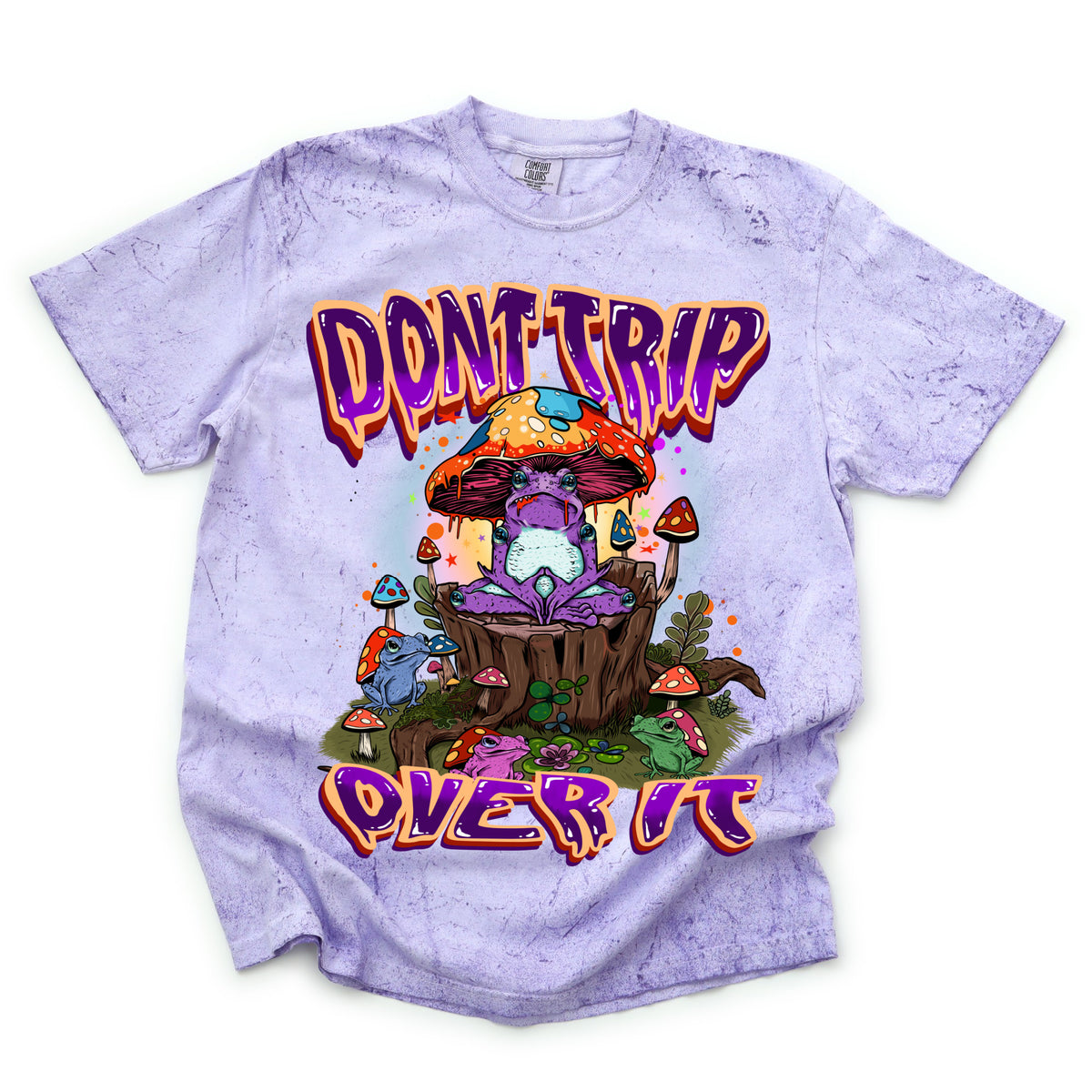 A graphic tee with a colorful design featuring mushrooms and the phrases 'DONT TRIP' and 'OVER IT' on a purple background.
