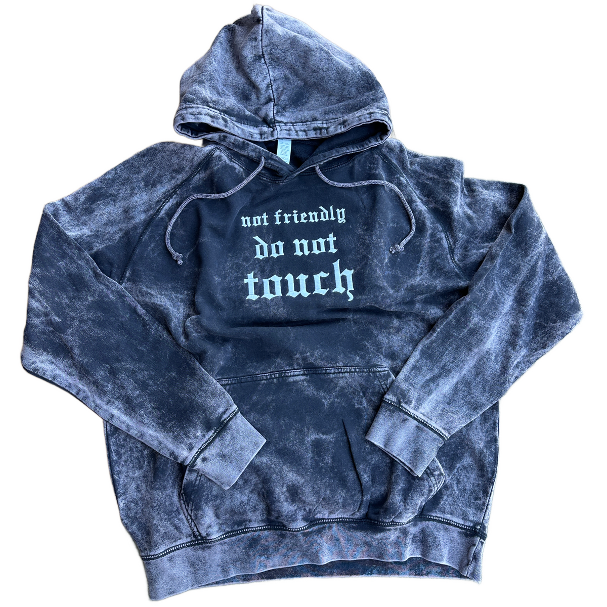 Vintage washed black pullover hoodie featuring white Old English embroidery that reads “not friendly do not touch” across the chest, with an adjustable drawstring hood, kangaroo pocket, and ribbed cuffs and hem.
