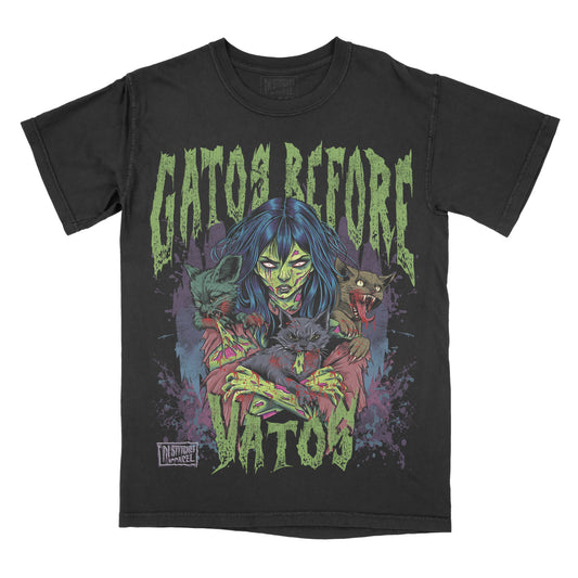 A black graphic tee with the text 'Gatos Before Vatos' and an image of a woman and cats printed on the front.