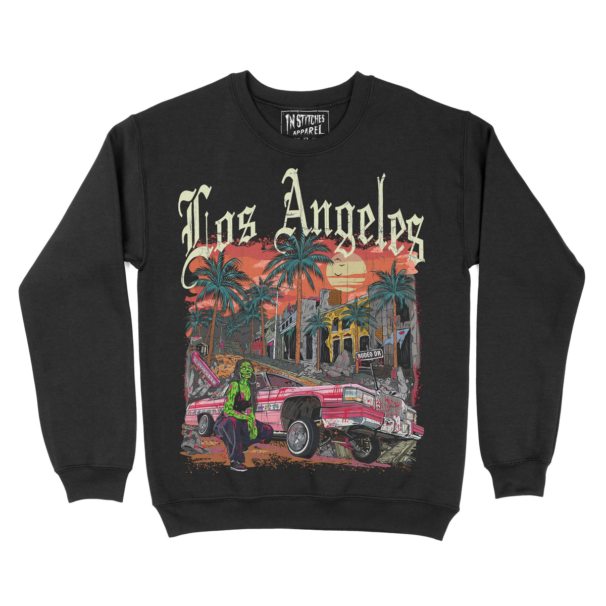 Black crewneck sweatshirt featuring the phrase ‘Los Angeles’ above a colorful illustration of palm trees, a lowrider car, and a sunset city scene. Zombie girl models by car