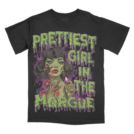 A black graphic tee with the text ' Prettiest Girl In The Morgue' and an illustration of a female figure with purple and pink accents.