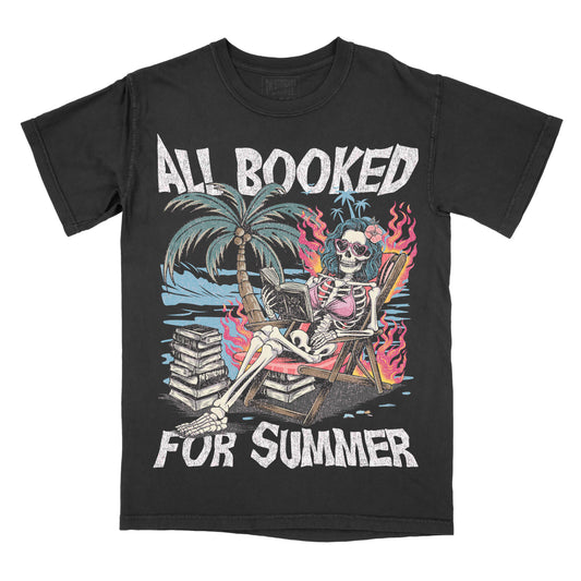 Black graphic tee with a design featuring a skeleton sitting on a beach chair with text 'ALL BOOKED FOR SUMMER' and palm trees in the background.
