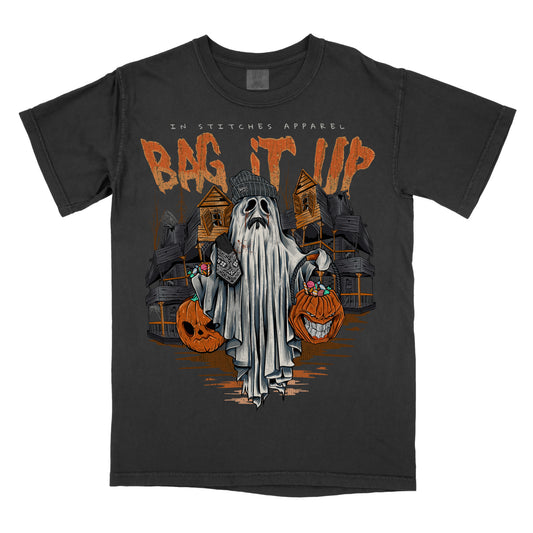 Black t-shirt featuring a ghost holding jack-o’-lanterns with orange text reading “Bag It Up.”