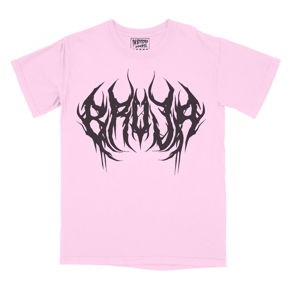 Pink graphic tee with 'Bruja' text in a stylized font and a graphic design in black.