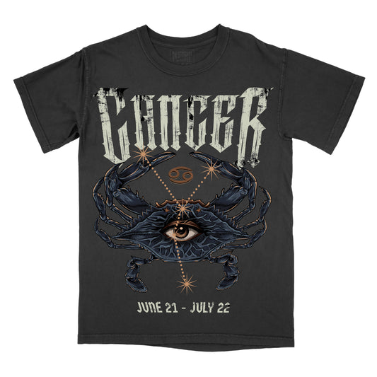 Graphic tee with a design featuring a crab and zodiac elements on a black background, with the text 'CANCER' above the graphic and 'JUNE 21 - JULY 22' below it.