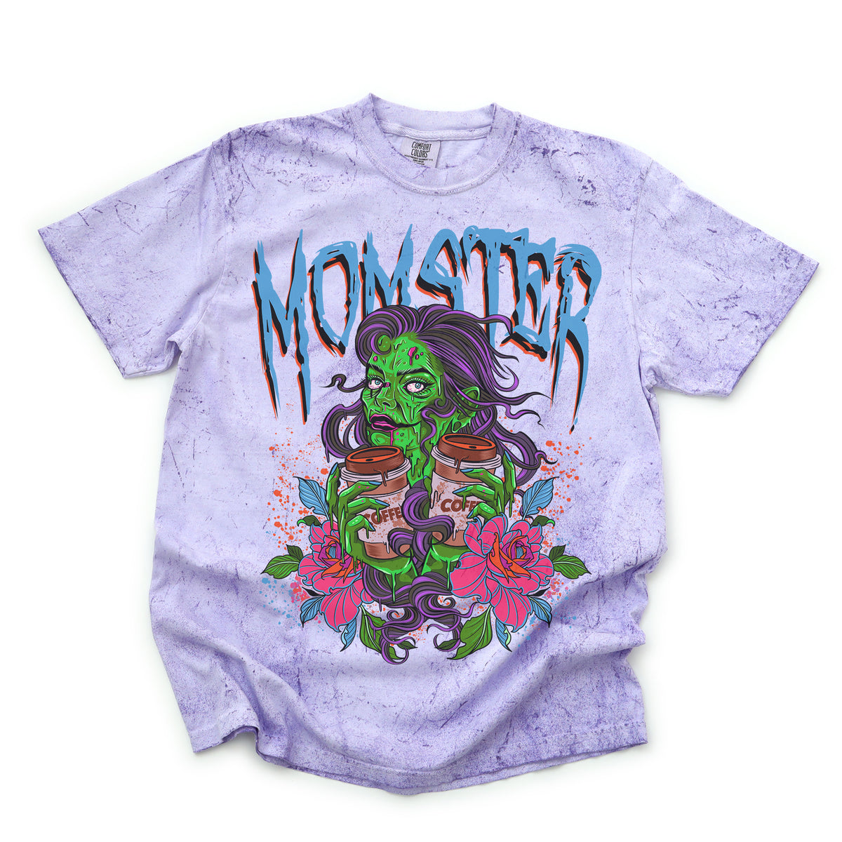 A graphic tee with a large print of a green monster character, surrounded by pink and purple floral designs, with the word 'MOMSTER' written across the chest in bold, blue letters.