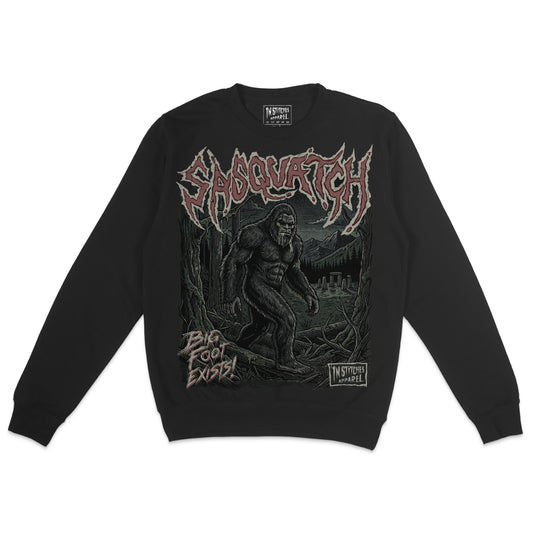 Black crewneck sweatshirt featuring a vintage Sasquatch Bigfoot graphic with distressed red lettering and a dark forest scene.