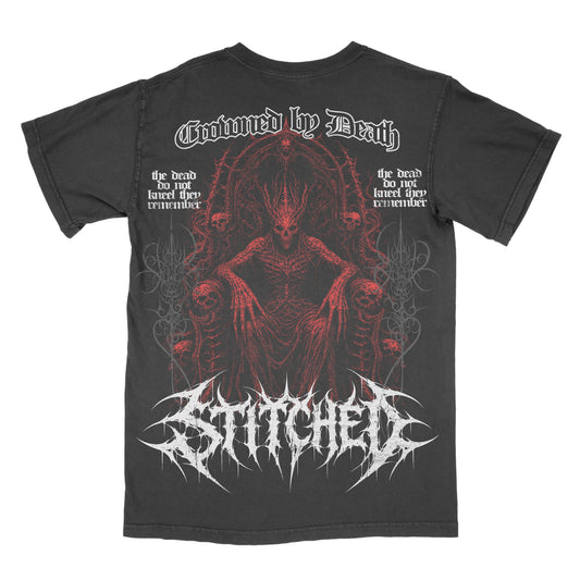 Back of a black vintage-wash Crowned by Death graphic tee featuring a red skeletal demonic figure seated on a throne surrounded by skulls and gothic details. White “Crowned by Death” lettering appears across the top with an oversized white Stitched logo across the bottom.