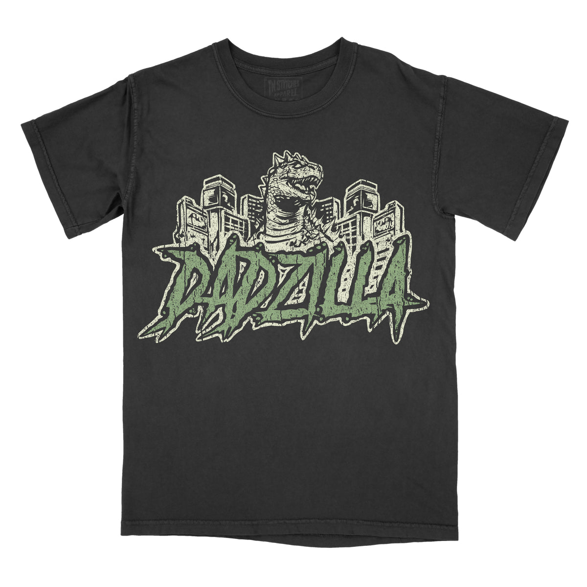 Black vintage-wash graphic T-shirt featuring a retro Godzilla-inspired monster towering over a city skyline above bold green graffiti-style lettering that reads "DADZILLA."