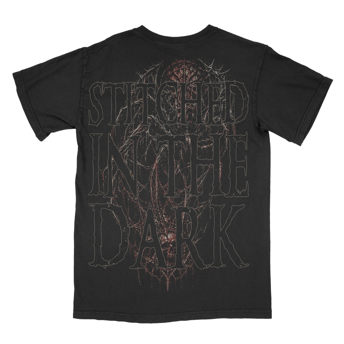 Back view of a black vintage-wash graphic tee featuring oversized distressed “Stitched in the Dark” lettering layered over a dark gothic skeletal figure, tangled web-like details, and muted red accents.
