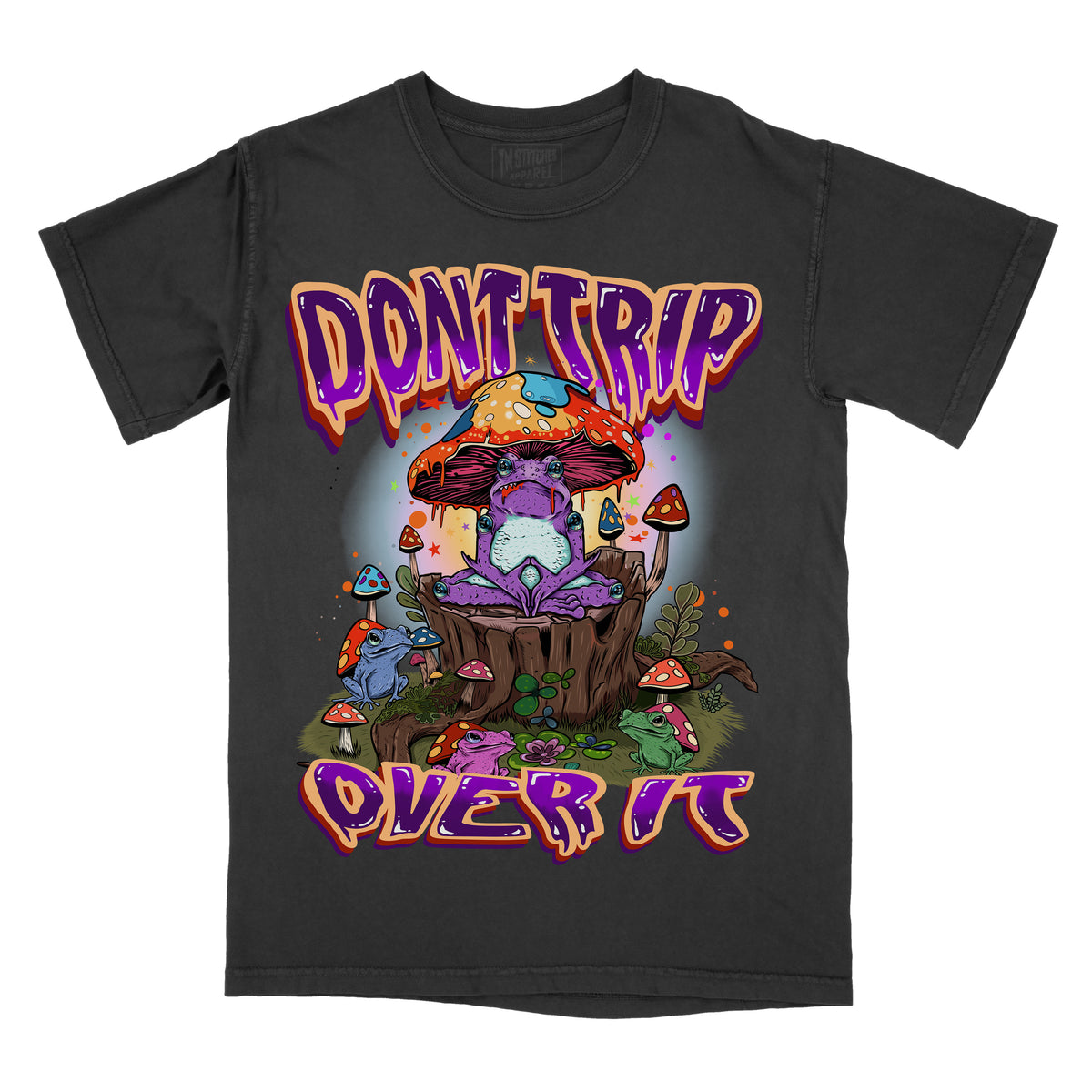 A graphic tee with the text 'DONT TRIP' and 'OVER IT' on a colorful, fantastical illustration background featuring mushrooms and other elements.
