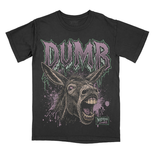 A black graphic t-shirt featuring a screaming donkey illustration and the word 'DUMB' in a stylized purple and green font.