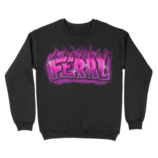 Black crewneck sweatshirt shown from the front, featuring a purple flame-style graphic with the word “FERAL” across the chest.