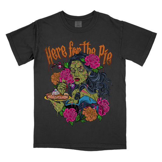 Black t-shirt with a graphic print of a zombie character eating a pie, surrounded by floral elements and the text 'HERE FOR THE PIE'.