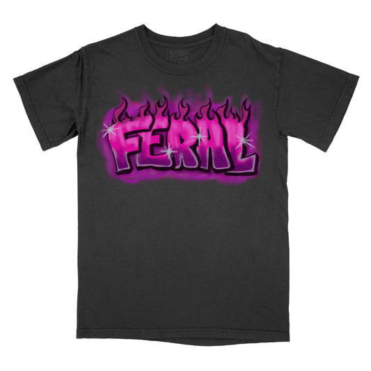 A black graphic tee with a vibrant pink and purple flame design and the word 'Feral' in the center.