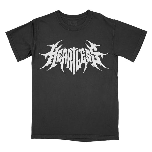 Black T-shirt featuring the word "HEARTLESS" in a white heavy metal-inspired font with sharp, pointed lettering and a symmetrical design.