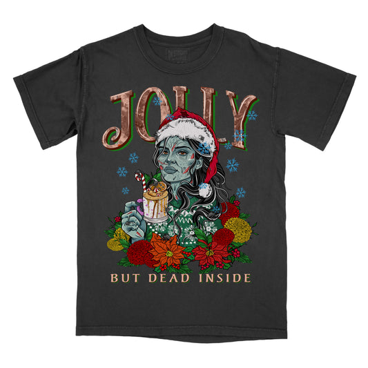 Black t-shirt with a graphic print of a character in a Santa hat holding a mug, surrounded by Christmas-themed decorations with the phrase jolly but dead inside