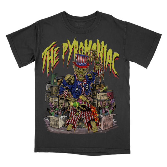 Black graphic tee with a patriotic-themed illustration featuring a character with an American flag and the text 'THE PYROMANIAC'.