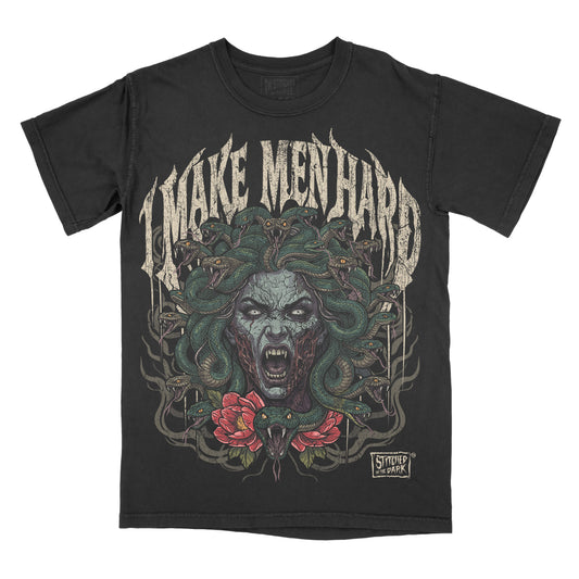 black T-shirt featuring a dark horror-style Medusa with green snakes for hair and red flowers, with distressed gothic text reading “I Make Men Hard” and Stitched in the Dark branding.