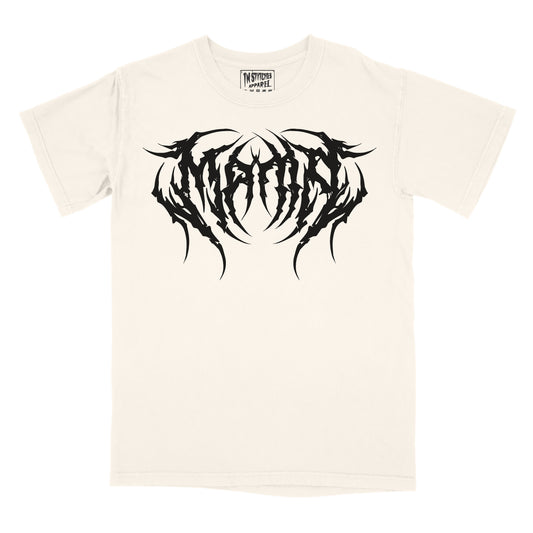 A cream graphic tee with the word 'MAMA' printed in a large, black, metal font across the chest.
