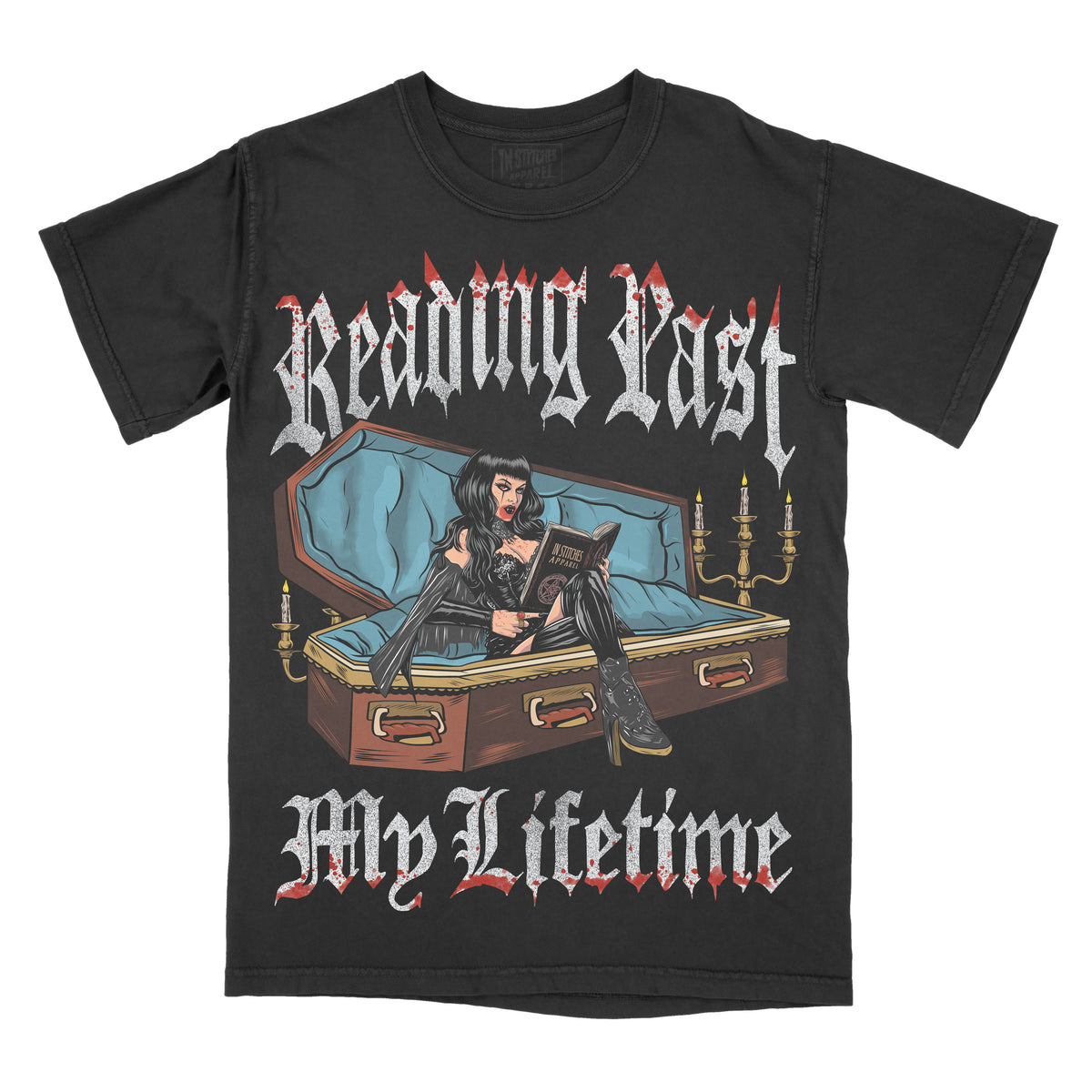 Black graphic t-shirt featuring the phrase “Reading Past My Lifetime” in gothic-style lettering above and below an illustration of a gothic woman sitting on a coffin while reading a book, with candles and dark decorative details.
