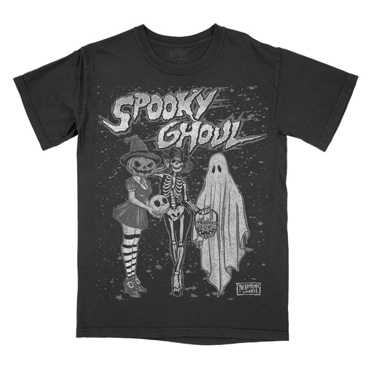 A black short-sleeve graphic t-shirt featuring a Halloween-themed illustration of a skeleton, a jack-o'-lantern, and a ghost with the text 'Spooky Ghoul' across the chest.