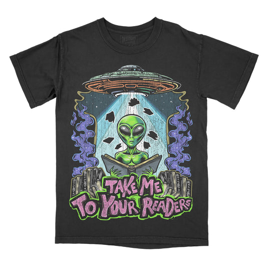 A black graphic tee with a design featuring an alien in a spaceship with the text 'Take Me To Your Readers'.