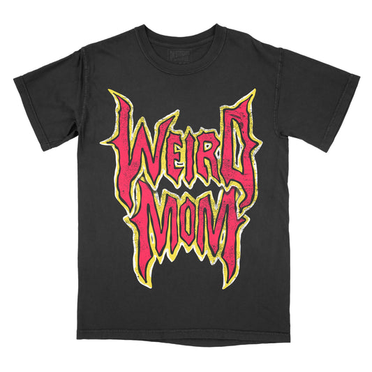 Black garment-dyed graphic t-shirt featuring the phrase "Weird Mom" in bold gothic-inspired typography with distressed vintage styling.
