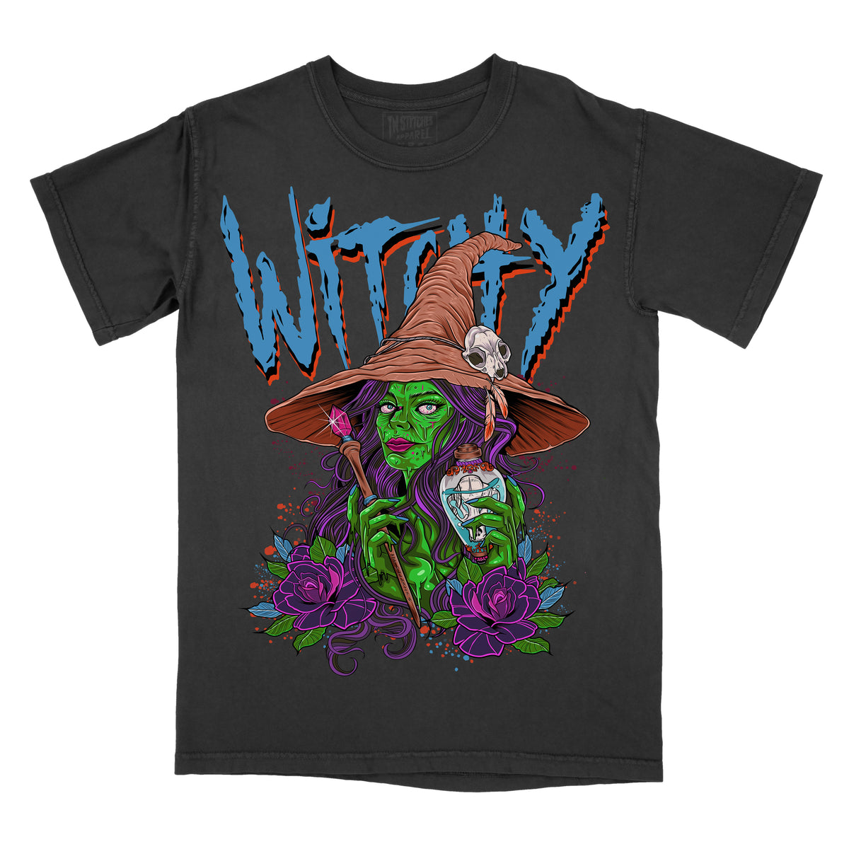 Black graphic T-shirt shown from the front featuring a green witch illustration holding a potion bottle, surrounded by purple flowers, with the word “WITCHY” across the top.