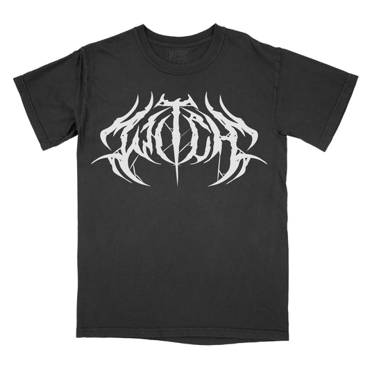 Black T-shirt featuring the word "WITCH" in a white heavy metal-inspired font with mirrored, jagged lettering, pointed spikes, and subtle spiderweb details.